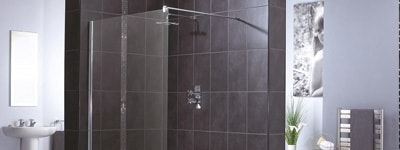 Shower enclosure with grey tiled bathroom wall