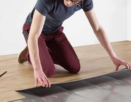 Man installing LVT flooring