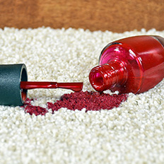 Spilt red nail varnish on carpet