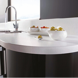 Curved kitchen worktop with bowls of fruit
