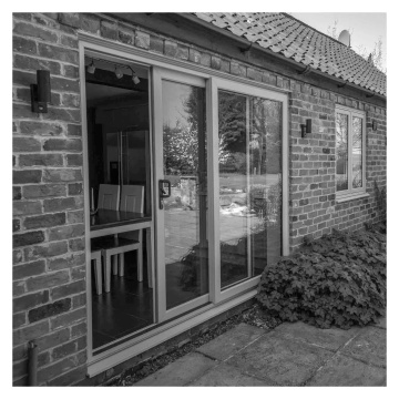 Crystal Clear Glazed Left to Right Grey/White uPVC Sliding Patio Door