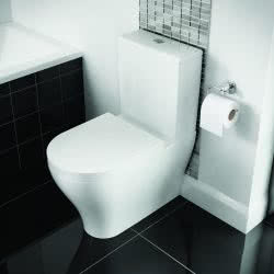 Close coupled toilet with black tiles