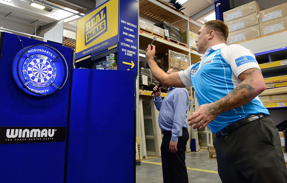 Darts pro Gerwyn Price playing darts in Selco branch