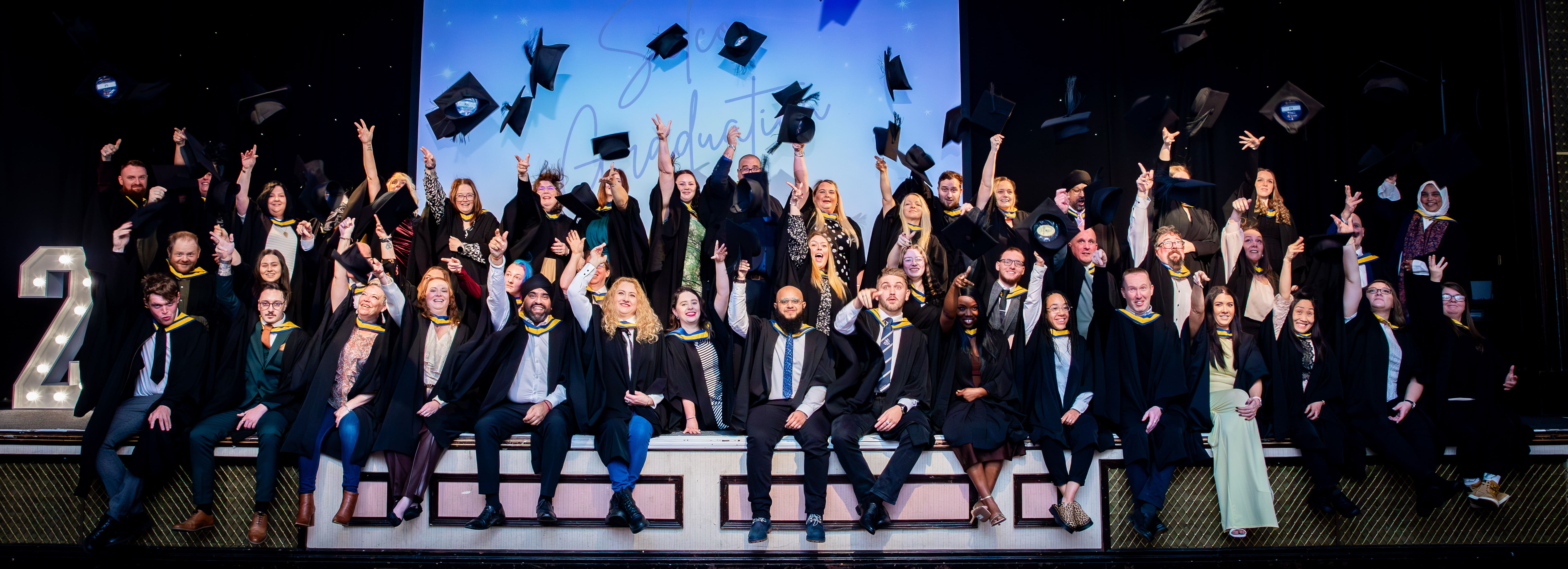 Selco Apprentice Graduates throwing their caps in the air