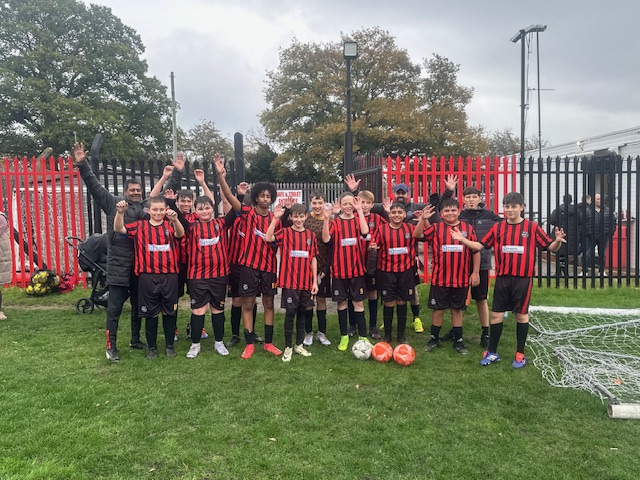 Maypole FC players cheering and celebrating