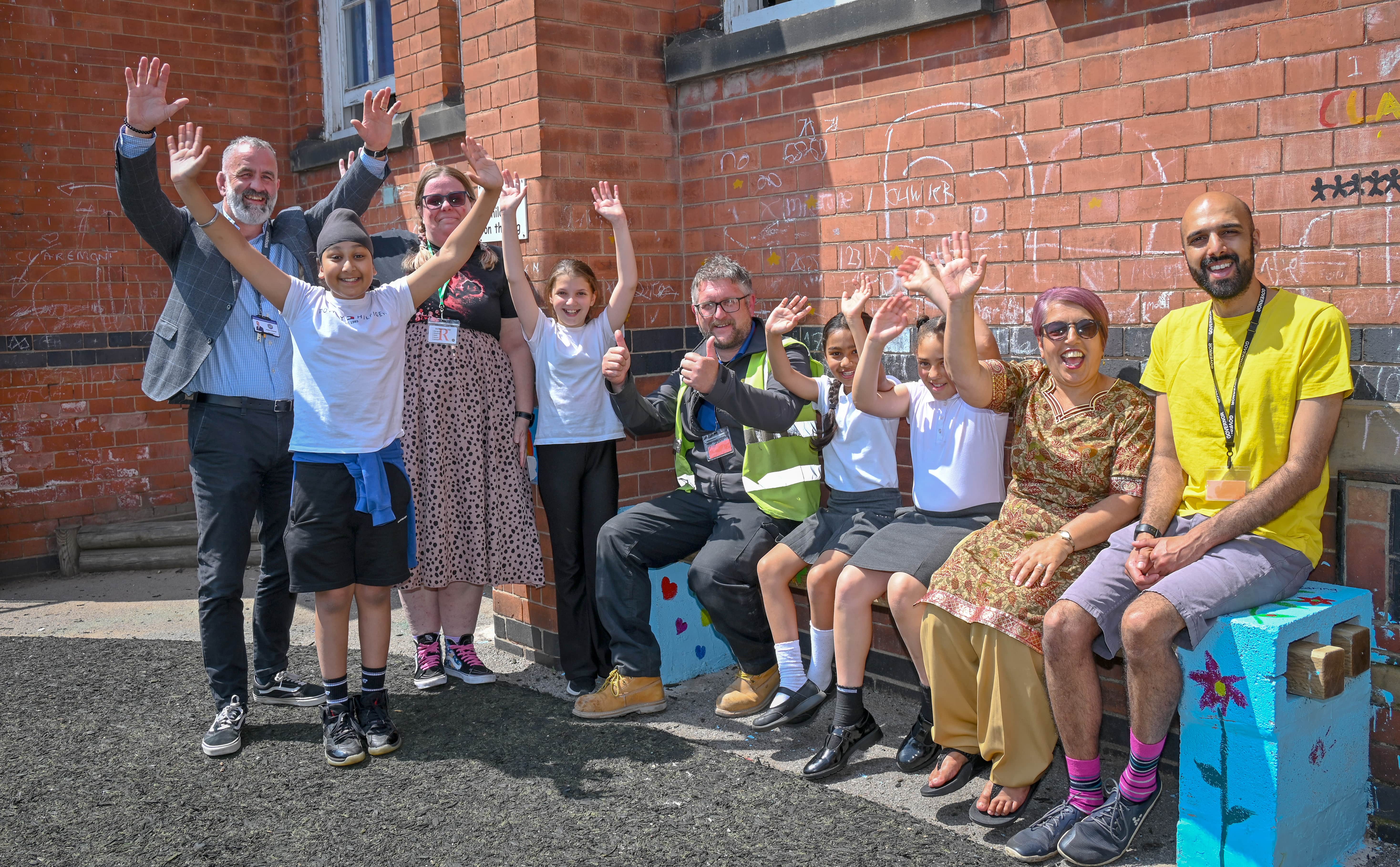 Pupils and teachers sat on Nottingham School Buddy Bench