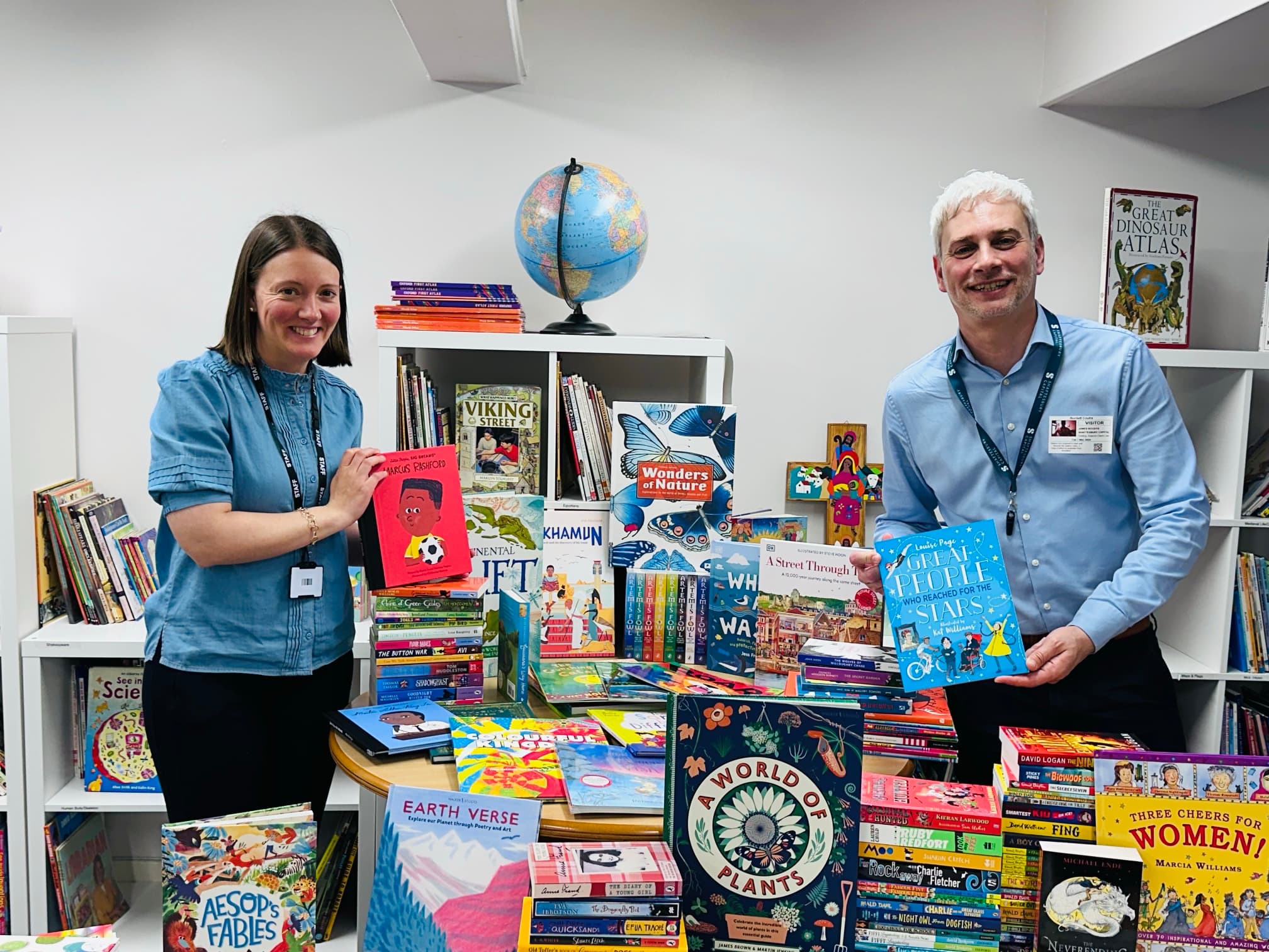 Reading Bridge members in a room full of children's books