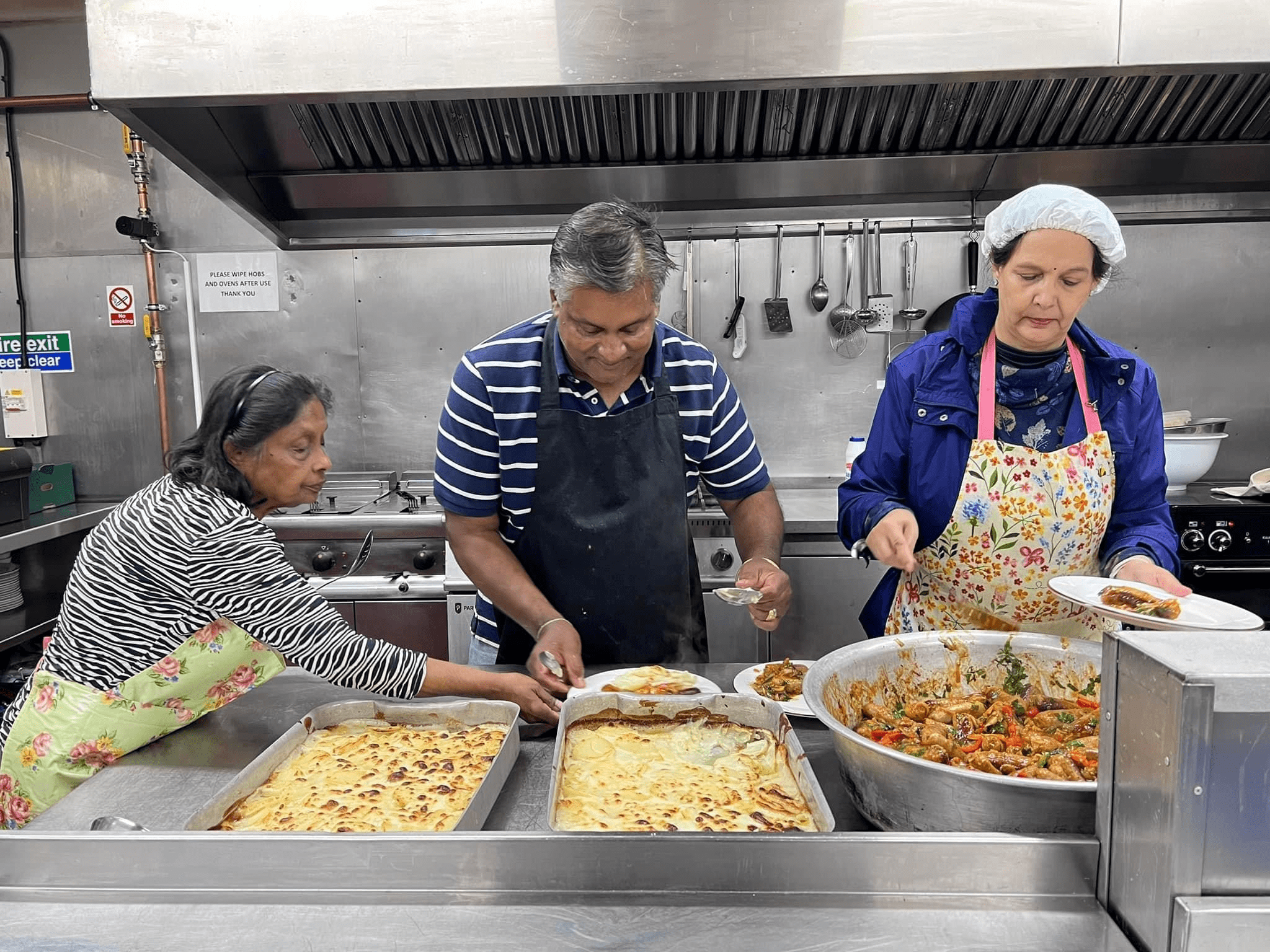 Sanctus charity volunteers cooking food in restaurant