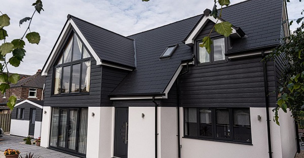 House with white render and black roof