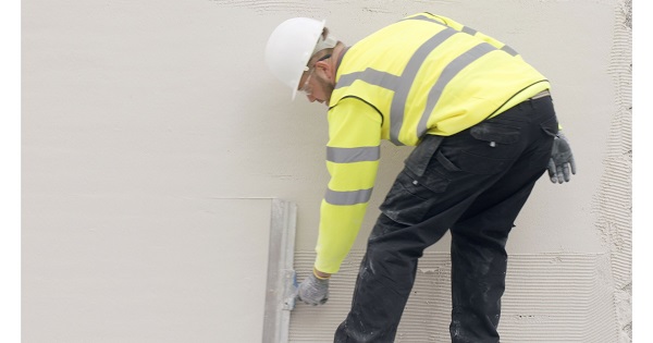 Man applying render to wall