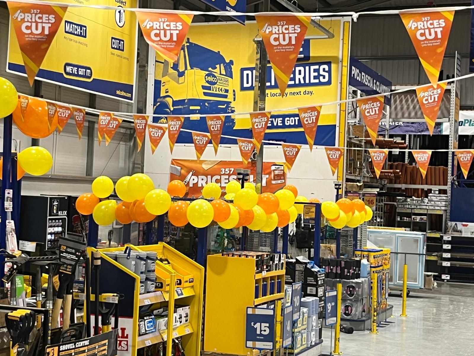 Selco in store Price Cuts display with orange bunting, balloons and posters