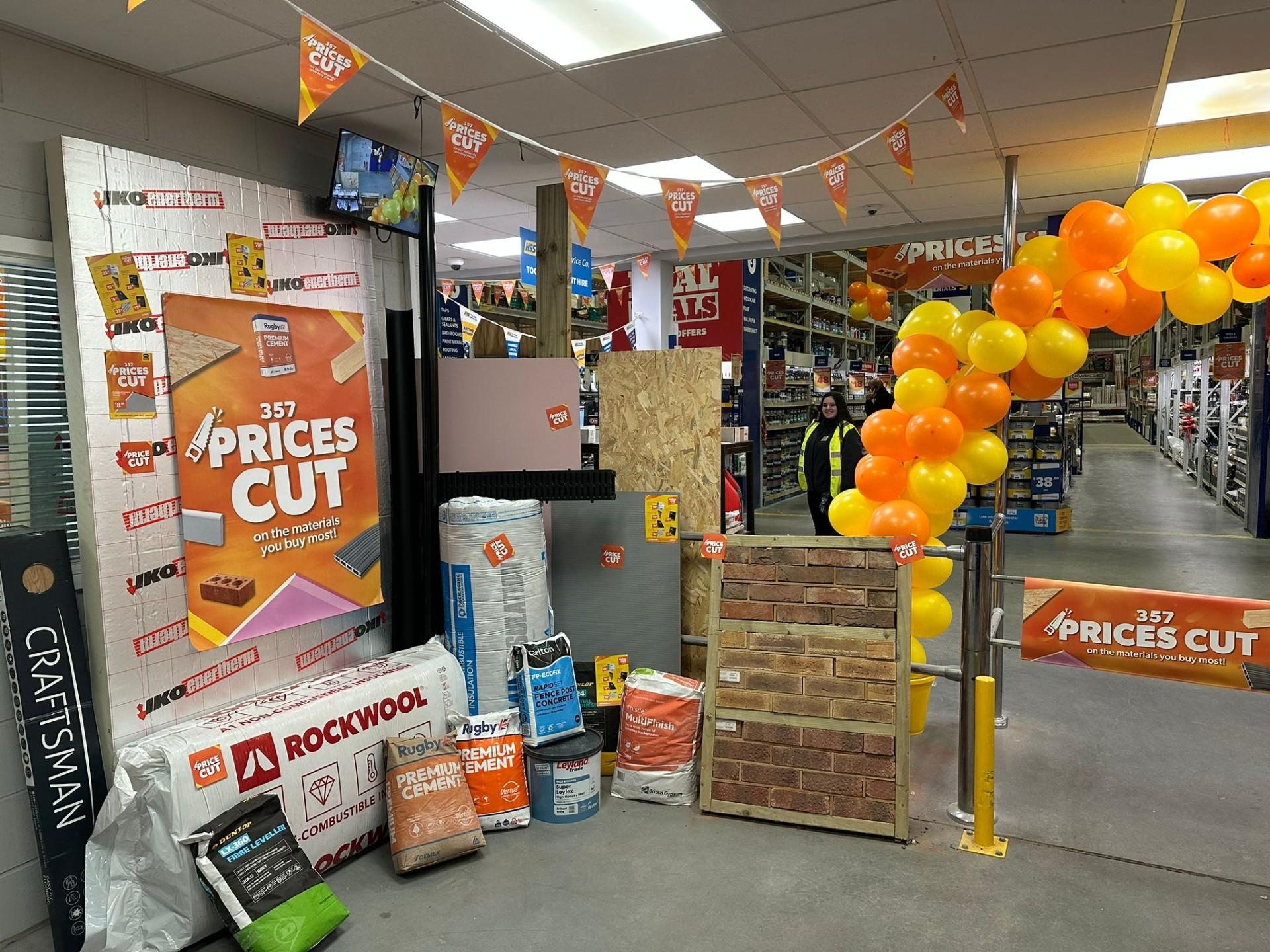 In-store orange Selco Price Cuts display with products