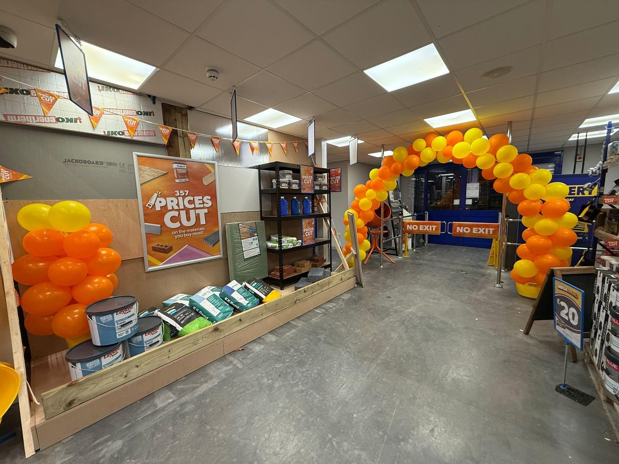 Selco in-store Price Cuts display with balloons, signs and products